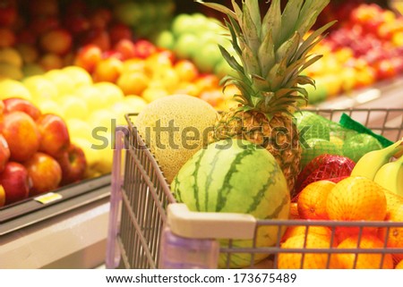 Shopping Cart Full Of Fruit at the supermarket. Selective Focus, Grocery Shopping for fruit.