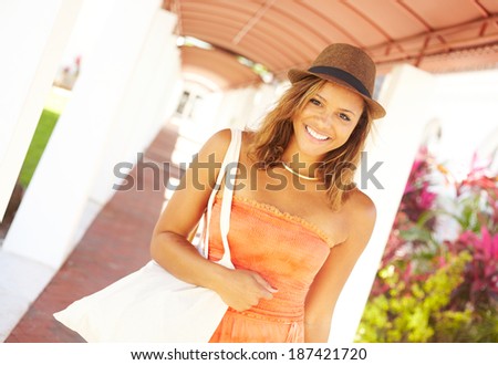 Beautiful Smiling African American Woman Wearing Hat With Shopping Bags. Horizontal Shot, copy space, color image