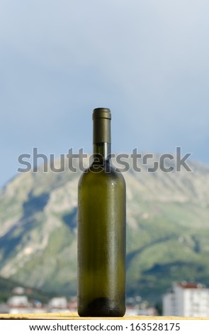 Foggy white wine glass bottle with no label on outside in natural light