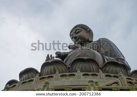 HONG KONG - JUNE 21: Tian Tan Giant Buddha , situated on Ngong Ping plateau,  on June 21 2014. It is a major of Buddhism ,is the centre of Lantau a popular tourist is also  attraction in Hong Kong