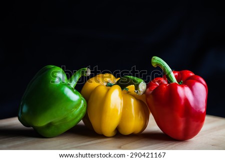 Colorful paprika, food styling on wood