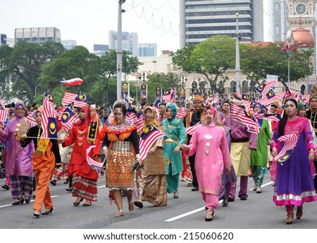 KUALA LUMPUR - AUGUST 31: Multi ethnic with traditional wear during 57th Celebrations, Malaysian Independence Day Parade on August 31, 2014 in Kuala Lumpur, Malaysia.