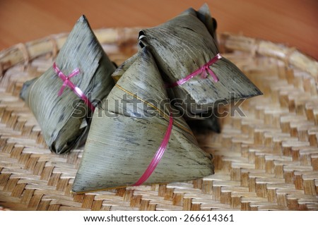 Chinese rice dumplings or zongzi a traditional Chinese food, made of glutinous rice stuffed with different fillings and wrapped in bamboo, reed or large flat leaves. Its served during festival.