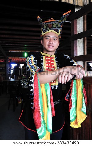 KOTA KINABALU, MALAYSIA - MAY 30, 2015: Portrait of young man of Kadazandusun ethnic in traditional costumes during the State Harvest Festival Celebration in KDCA, Kota Kinabalu, Sabah.