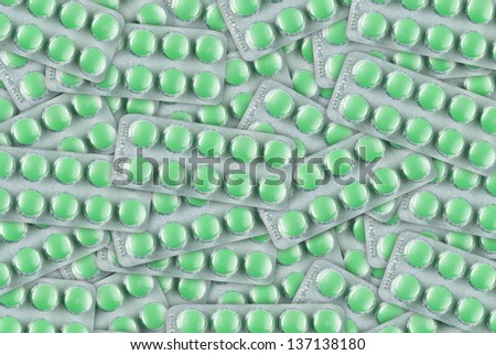 Abstract background of green pills in blister