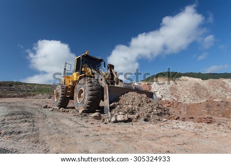bulldozer loader at winter frozen soil excavation works