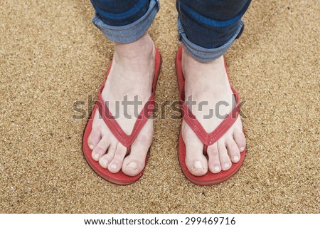 flip flops on a woman on the beach