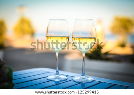 two glasses of tasty white wine at sunset