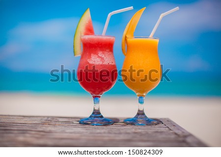 Close up fresh watermelon and mango cocktails on the background of stunning turquoise sea