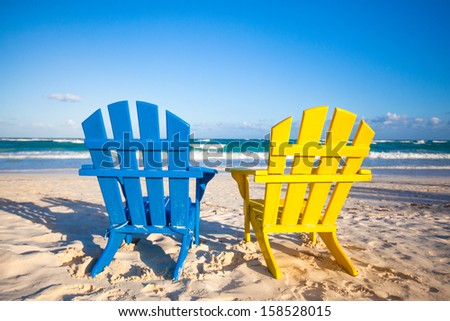 Beach wooden colorful chairs for vacations and summer getaways in Tulum, Mexico