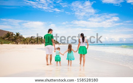 Back view of young family looking to the sea in Mexico beach