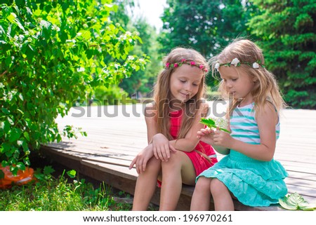 Happy adorable girls enjoy summer day play in the park