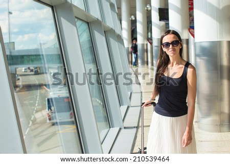 Young woman with luggage at the international airport