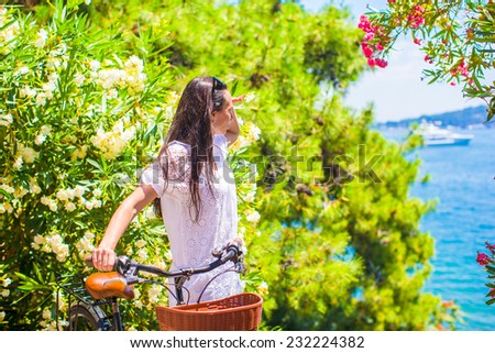 Young woman on summer vacation biking at tropical island