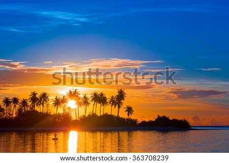 Beautiful colorful sunset at tropical island on Maldives in Indian Ocean