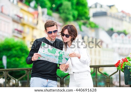 Happy tourist couple traveling on holidays in Europe smiling happy. Caucasian couple.