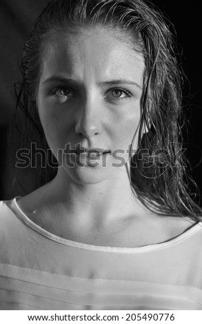 black and white portrait of a girl model with wet hair on a black background