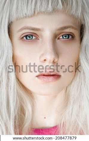 portrait of blue-eyed blonde with a bang
