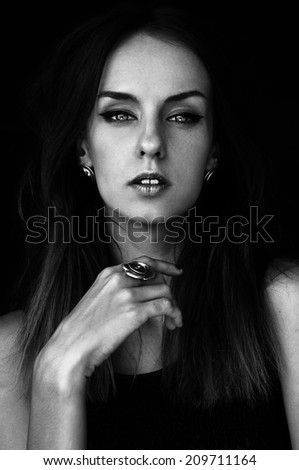 black and white portrait of a girl with makeup and strong face