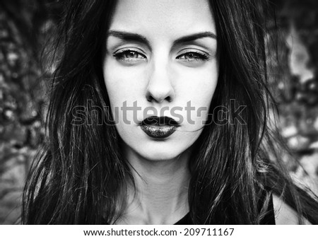 black and white portrait of a girl with makeup and strong face