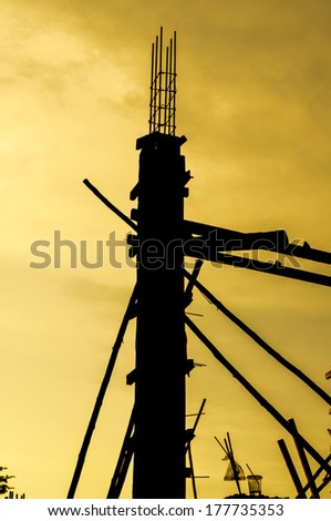 Construction site, silhouettes of workers against the light