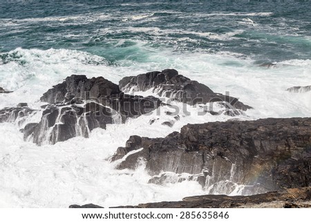 View from Pendeen lighthouse with waves crashing against the shore. cornwall England UK.