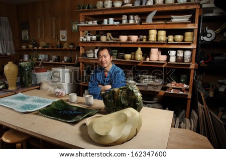 Japanese Pottery Master/ Master pieces on display/A Japanese pottery master posing with some of his works of art in his studio