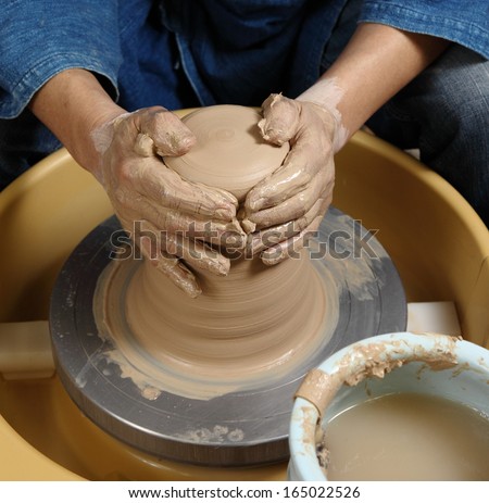 Japanese pottery master/The birth/Japanese pottery master in his studio giving birth to a new creation.