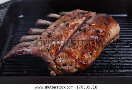 Tasty rack of lamb/Rack of lamb/A tasty rack of lamb grilling in a heavy pan.