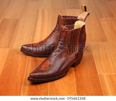 TOKYO, JAPAN - MAY 30, 2014: A photo of genuine python leather men\'s boots. Custom made by the Friendship Leatherwear company in Phuket Thailand. Friendship leatherwear sell products worldwide.