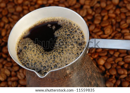 Close-up of a coffee maker on the coffee beans