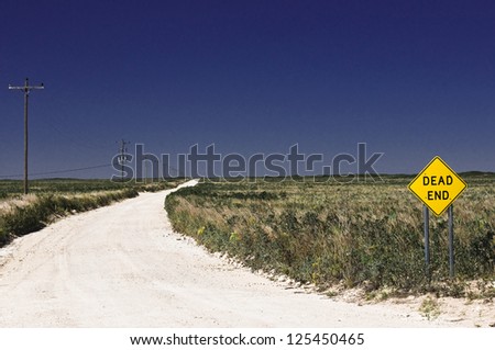 Road to Nowhere - gravel road to dead end in empty prairie