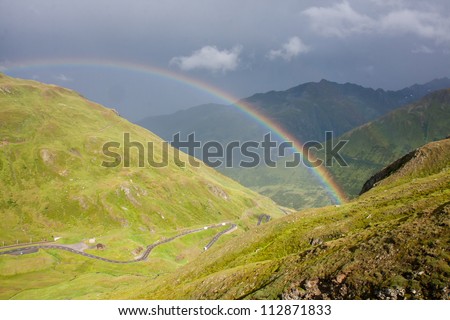 Rainbow on Oberalppass, Alpine pass in cantons Graubuenden and Uri in Switzerland