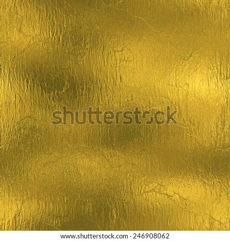 Golden Foil luxury seamless and tileable background texture. Glittering holiday wrinkled gold background and shiny bright metal surface backdrop.