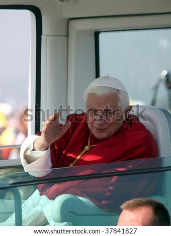 BRNO - SEPT 27: Holy father Pope Benedict XVI gestures as he greets about 120,000 pilgrims from central Europe as he travels in the Pope Mobile on mass on September 27, 2009 in Brno, Czech Republic.