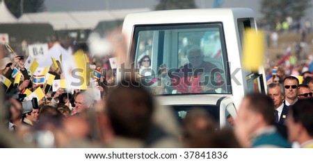 BRNO - SEPT 27: Holy father Pope Benedict XVI gestures as he greets about 120,000 pilgrims from central Europe as he travels in the Pope Mobile on mass on September 27, 2009 in Brno, Czech Republic.