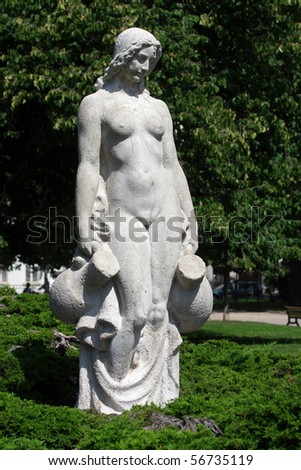White statue of woman in the city park