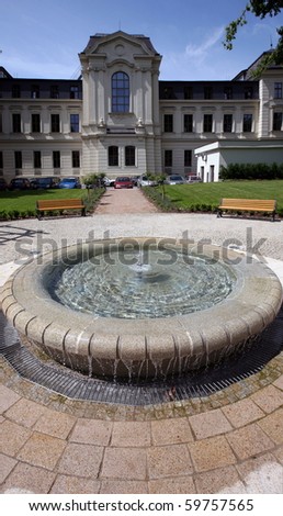 Garden of historical building with small fountain