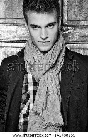 Elegant young handsome man. Studio fashion black and white portrait