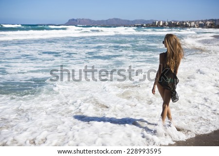beautiful back and ass woman in bikini posing tropical blue sea water has sports and tan body