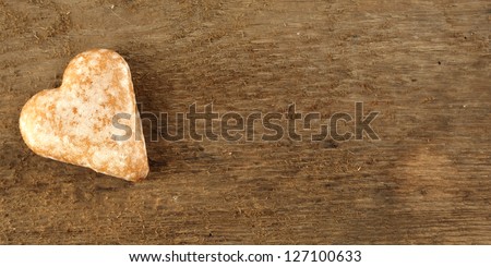 background of wooden desk and single cookie of love
