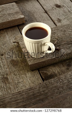 single cup of coffee on worn table