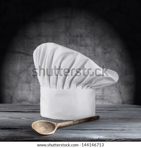 single cook cap and one wooden spoon