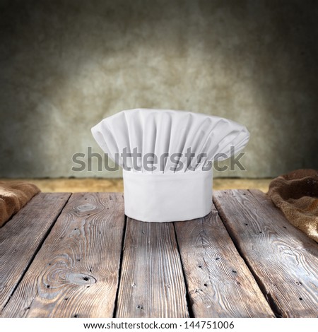 single hat of cook on wooden table