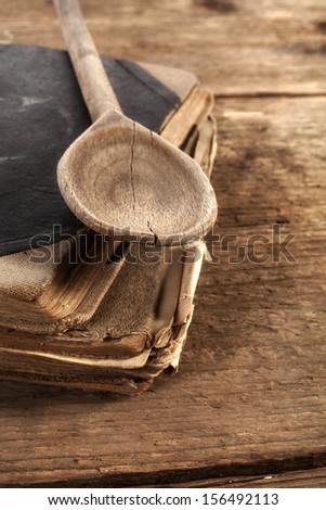 old spoon of book on table with cook books