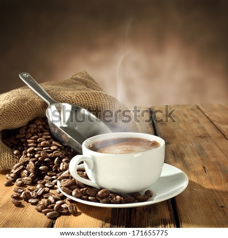 background of fresh coffee beans and warm cup