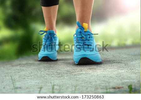 sport in park and blue shoes on track
