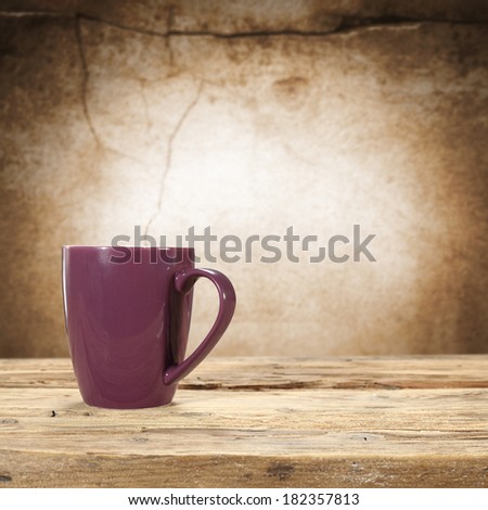 mug and dirty wall with sill of wood
