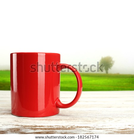 red mug on white desk and tree