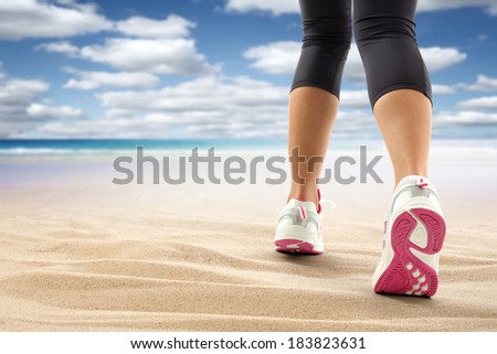 sport shoes of white and pink on sand